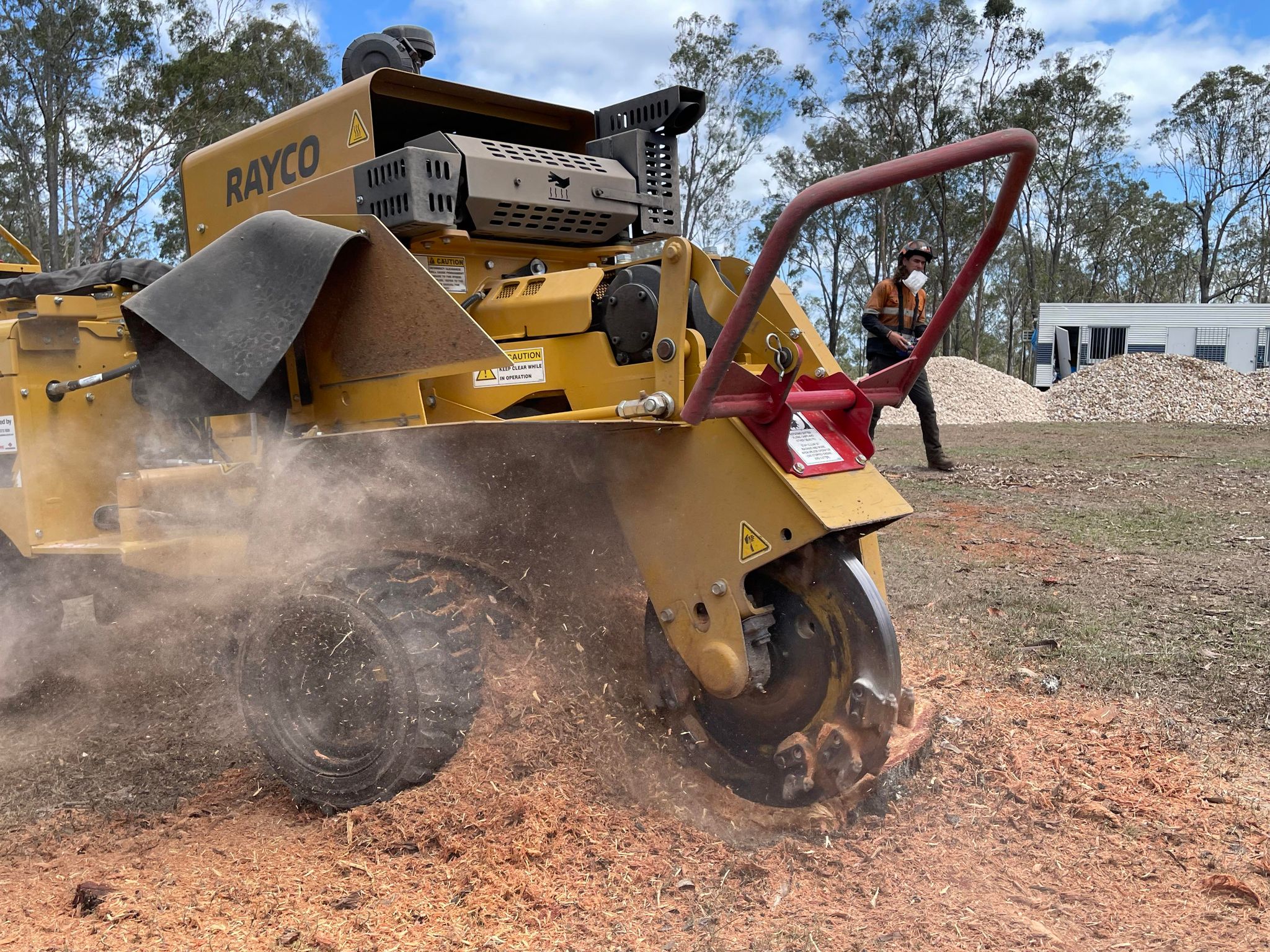 Professional stump grinding machine removing a tree stump to demonstrate the typical cost of stump grinding services.