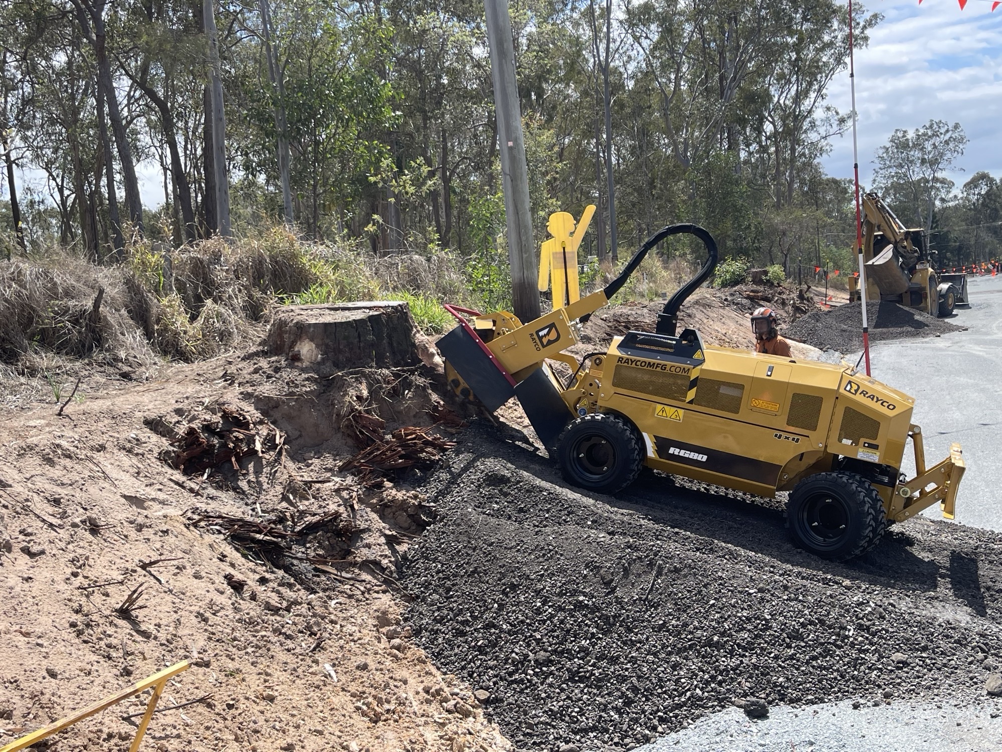 Professional stump grinding machine removing a large tree stump from a residential property on Brisbane's Northside.
