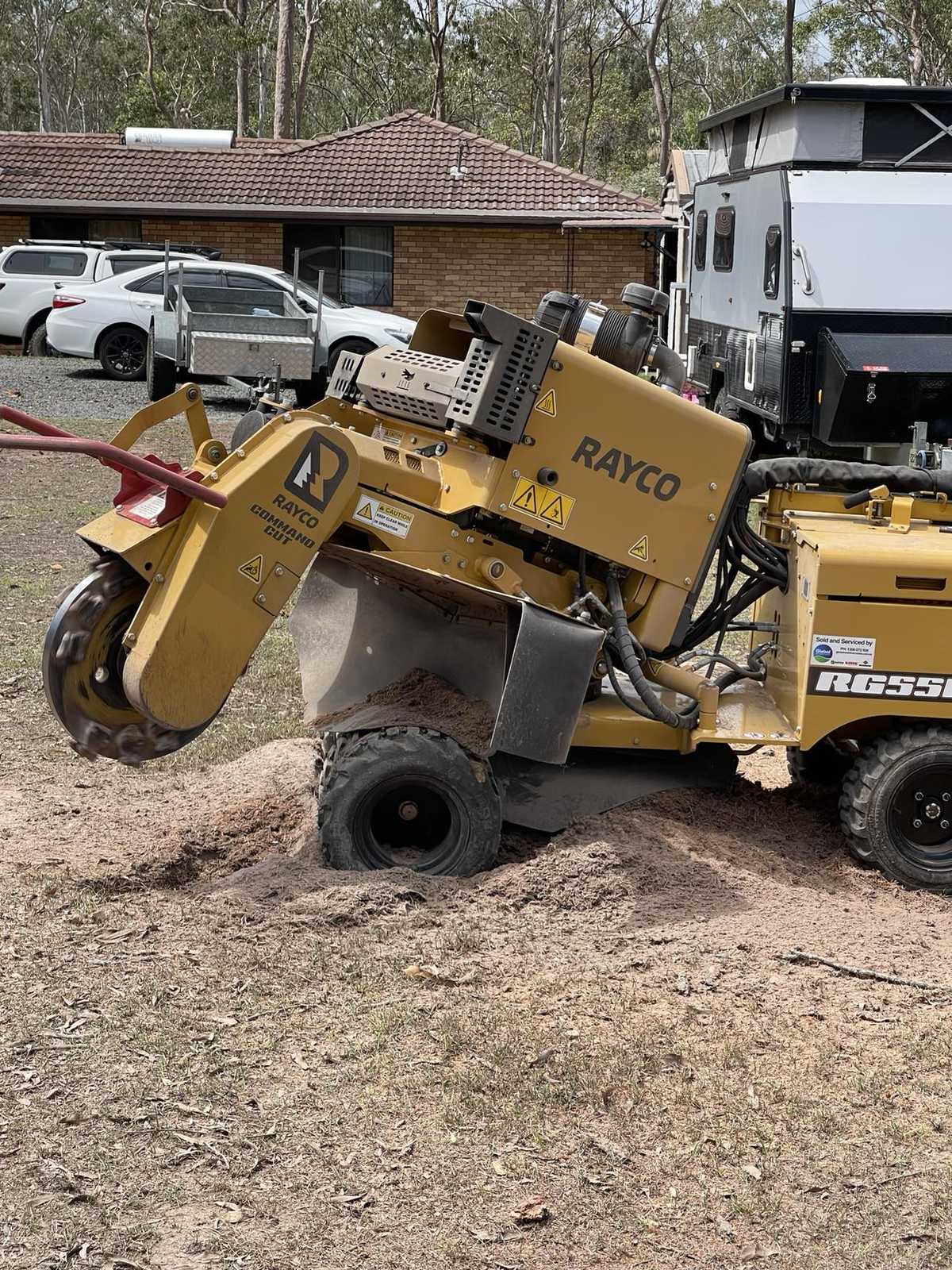 Rayco stump grinder on a freshly ground stump in a residential front yard, Brisbane south-west